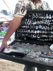 Beach vendor with a visa maechine