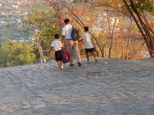 Dad waling sons to school hand in hand