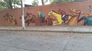 Horse race mural on wall coming back from the pool